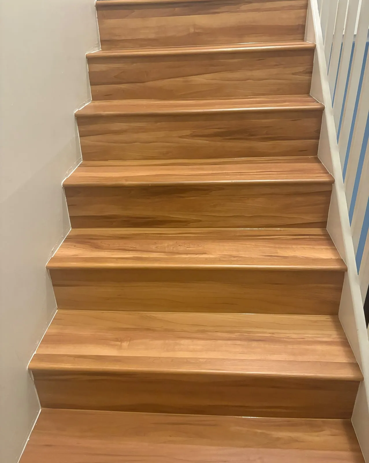 Straight staircase with new wood-look treads and risers