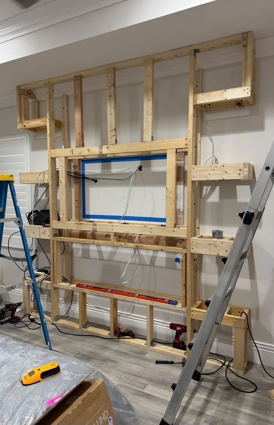 Wood framing for a TV and fireplace feature wall